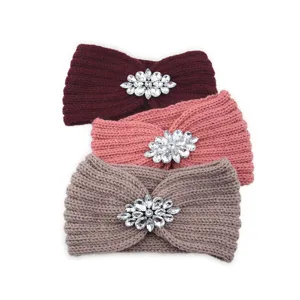 Close-up details of the warm knitted headband featuring sparkling crystal rhinestone flower decor.