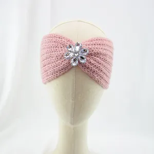 Pink knit headband detail, featuring sparkling crystal flower accent, soft winter ear warmer.