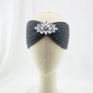 Rhinestone knit headband detail shot showing exquisite crystal flower brooch and warm texture.