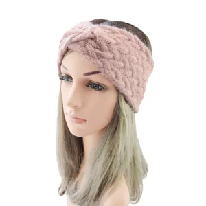 Close-up of pink knitted twist headband detail, soft woolen winter warm hair accessory.