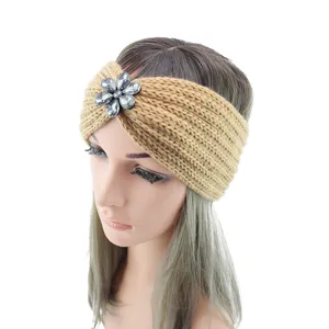 Knitted headband with rhinestone flower, cozy winter ear warmer and yoga hair accessory detail shot.