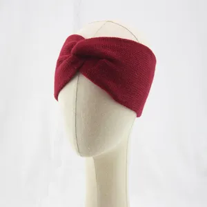 Detailed view of a cozy dark red knitted twist headband for women, autumn winter warmth.