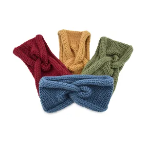 Detailed view of colorful knitted cross headbands, soft woolen ear warmers for autumn and winter.