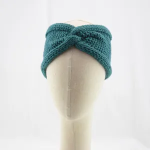 Dark teal knitted headband with front twist design, cozy warm winter ear warmer accessory.