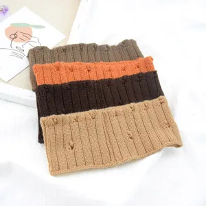 Close-up of distressed knit hair bands in various earth tone colors for casual and sports wear.