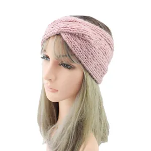 Close-up view of the cozy pink chunky knit twisted headband detail for winter wear and daily styles.