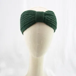 Dark green knitted headband detail, cozy wool bow hair accessory for winter warmth and styling.
