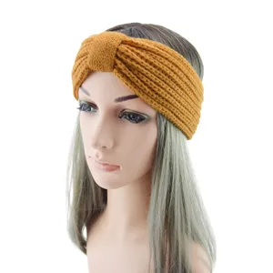 Detail view of the cozy mustard yellow knitted headband, showcasing the twisted knot texture.