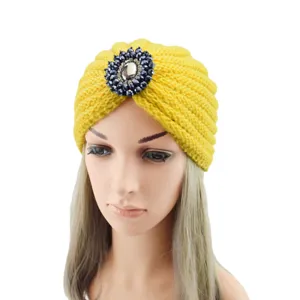 Yellow knitted turban hat featuring a sparkling crystal brooch, cozy boho winter headwrap.