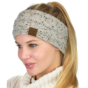 Knit headband detail view, cozy winter hair accessory with colorful speckles and logo patch.