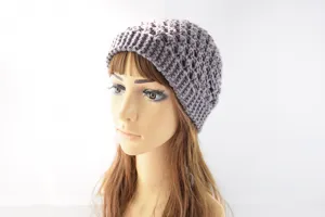 Vista detallada de un gorro de punto gris con patrón texturizado claro para invierno.