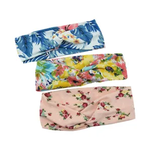 Vue rapprochée détaillée de trois bandeaux croisés à imprimé floral montrant la texture.