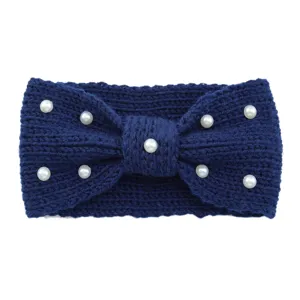 Close-up detail of navy blue knitted headband with chic bow and faux pearls for women.