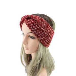 Close-up view of the knitted cross headband, showcasing detailed red and gold textured yarn.