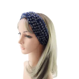 Knitted headband for women winter warm hair accessory with metallic gold thread knot design.