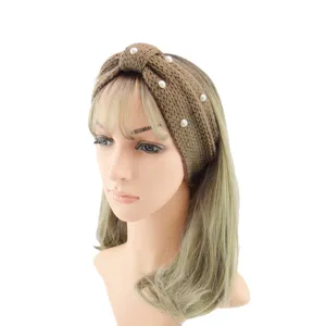 Close-up of the brown knitted pearl headband showing soft texture and elegant pearls.