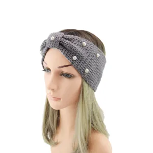 Detailed view of grey knitted headband with pearl embellishments and a stylish knot design.