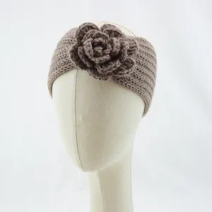 Detailed view of the handmade knitted floral headband, showing soft texture and cozy knit design.