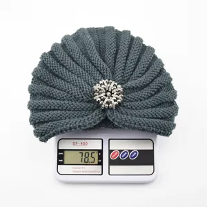 Dark grey knitted turban hat with silver rhinestone brooch, warm winter boho headwear.
