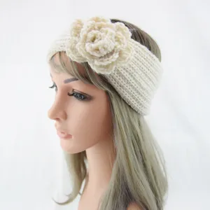 Close up view of beige knitted flower headband, soft woolen warm hair accessory detail.