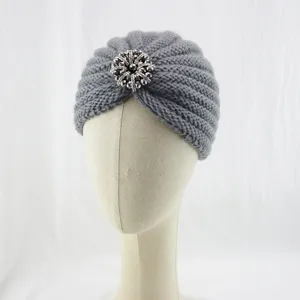 Grey knitted turban hat for women featuring a sparkling rhinestone crystal brooch detail.