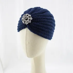Dark blue knitted turban hat featuring a sparkling rhinestone brooch detail for autumn winter.