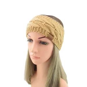 Close-up detail of the warm khaki cable knit headband featuring a stylish leather logo patch.