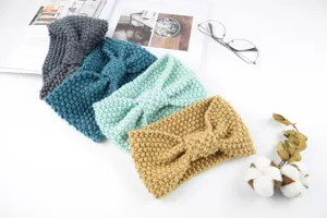 Detailed closeup view of four colorful knitted headbands with bowknot design for warm winter wear.