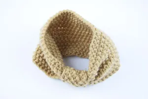 Detailed view of the cozy knit ear warmer headband in camel color with textured pattern.