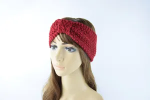 Detail view of the red knitted headband featuring a cute bow, warm and cozy for winter.