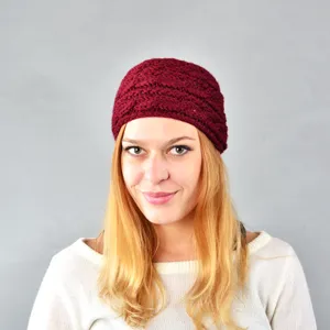 Wide knitted winter headband ear warmer in dark red, cozy handmade style hair accessory detail.