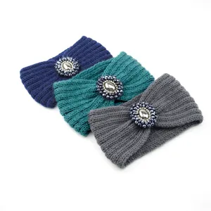 Knitted winter headband with sparkling crystal gemstone centerpiece, warm hair accessory.