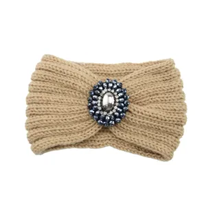 Knitted wool headband with rhinestone gemstone centerpiece, warm winter hair accessory.