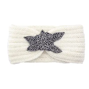 White knitted headband featuring a handmade beaded flower applique, warm and stylish for winter.