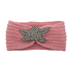 Pink knit headband with beaded flower applique, warm winter hair accessory for women.