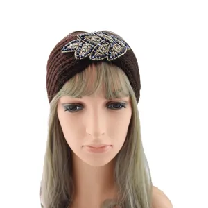 Detailed view of brown knitted rhinestone leaf headband, winter warm ear warmer hair accessory.