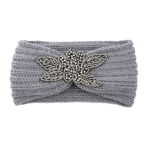 Grey knitted headband with metallic beaded flower detail, warm winter hair accessory.