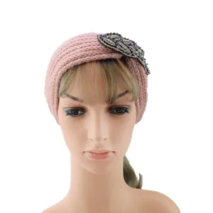 Close-up detail of the pink knitted headband featuring exquisite beaded leaf embellishments.
