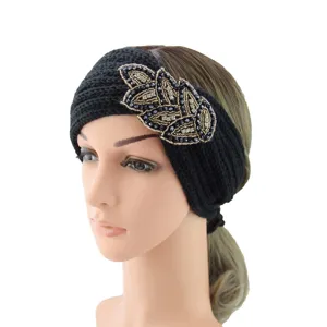 Detail view of black knitted winter headband featuring elegant beaded leaf crystal applique.