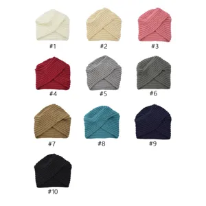 Detailed view of multiple colored knitted twist turban hats showing clear texture and fabric.