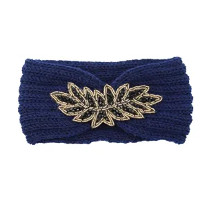 Blue knitted headband with sparkling rhinestone and bead leaf embellishment for winter warmth.