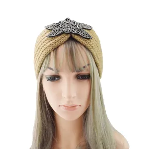 Knitted wool headband with rhinestone beaded star embellishment, warm winter hair accessory.