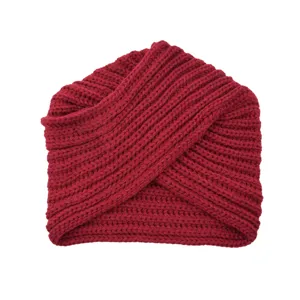 Close-up view of the dark red knitted turban hat, showing fine woolen texture and cross fold details.