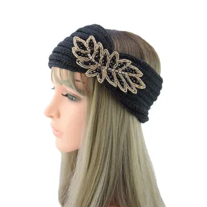 Detail view of the black knitted headband featuring exquisite beaded leaf applique.