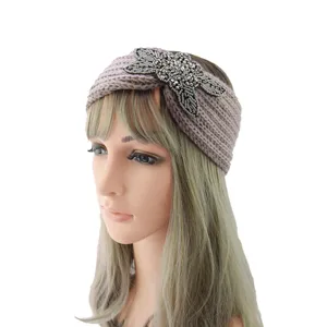 Close-up detail of a knitted winter wool headband featuring sparkling beaded floral embellishment.