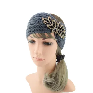 Grey knitted headband with beaded leaf detail, soft winter hair accessory, detail view.