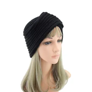 Detailed view of a black knitted turban hat, soft wool blend cross beanie for stylish women.