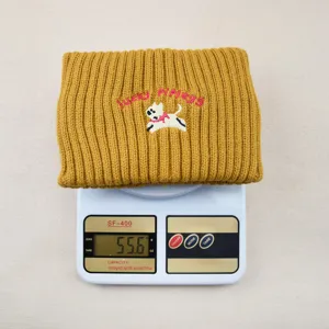 Yellow knit headband with cute dog embroidery and letter detail, warm winter hair accessory.