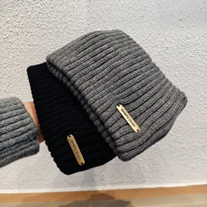 Solid color knitted winter beanie and headband, warm double layer woolly hat detail view.
