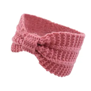Detailed view of the cozy pink knitted headband, featuring soft texture and stylish ear warmer design.